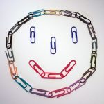 Smiley face made of paperclips.