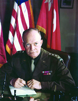 A photograph shows Dwight Eisenhower seated at a desk in his military uniform.