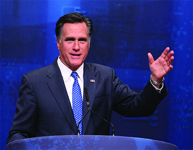 A photograph shows Mitt Romney speaking at a lectern.