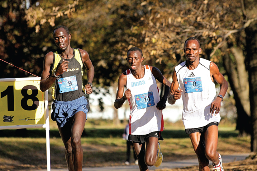 This photo shows three young men running in a competitive marathon.