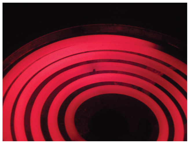 This photo shows a red hot electric stove top.