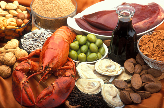 Photo shows a variety of foods, including lobster, clams, nuts and liver.