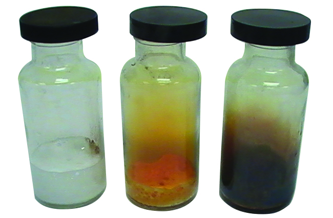 Three sealed glass vials are shown. The left vial contains a pale yellow gas and a colorless liquid, the middle contains an orange gas and solid, and the right contains a purple gas and solid.