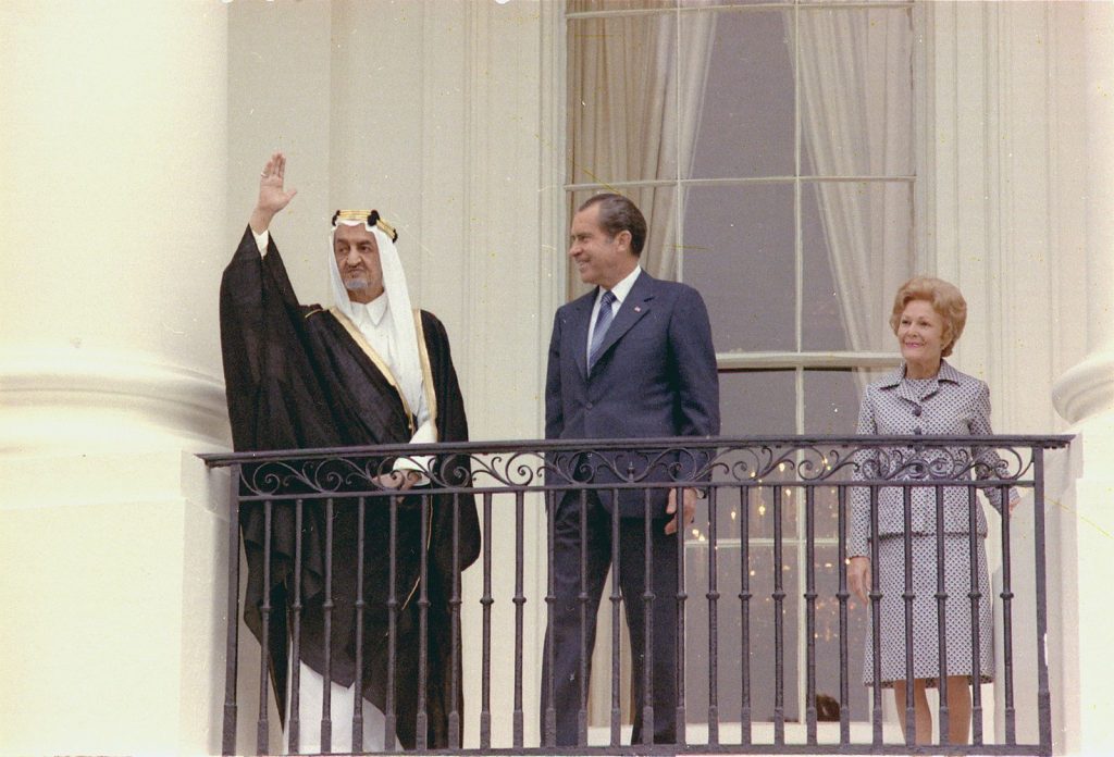 President Nixon and the first lady stand on a balcony during an arrival ceremony for King Faisal of Saudi Arabia
