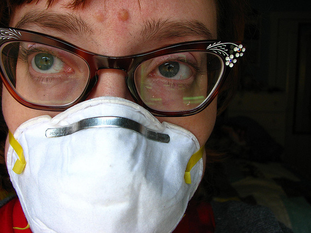 A woman wearing a mask to protect her breathing