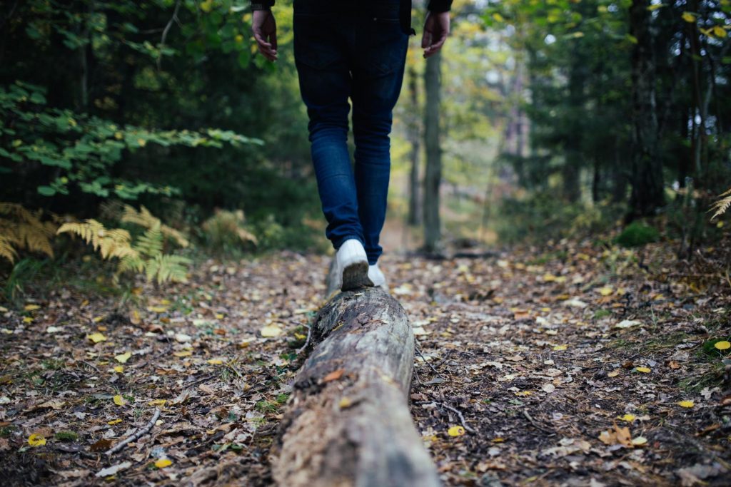 Hiker balancing on log