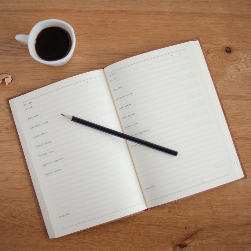 Pencil and notebook on table