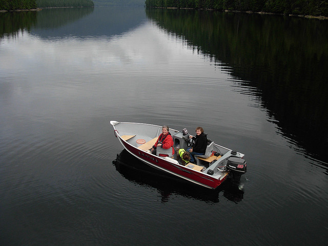 Two women sitting in a Lund boat in a big lake