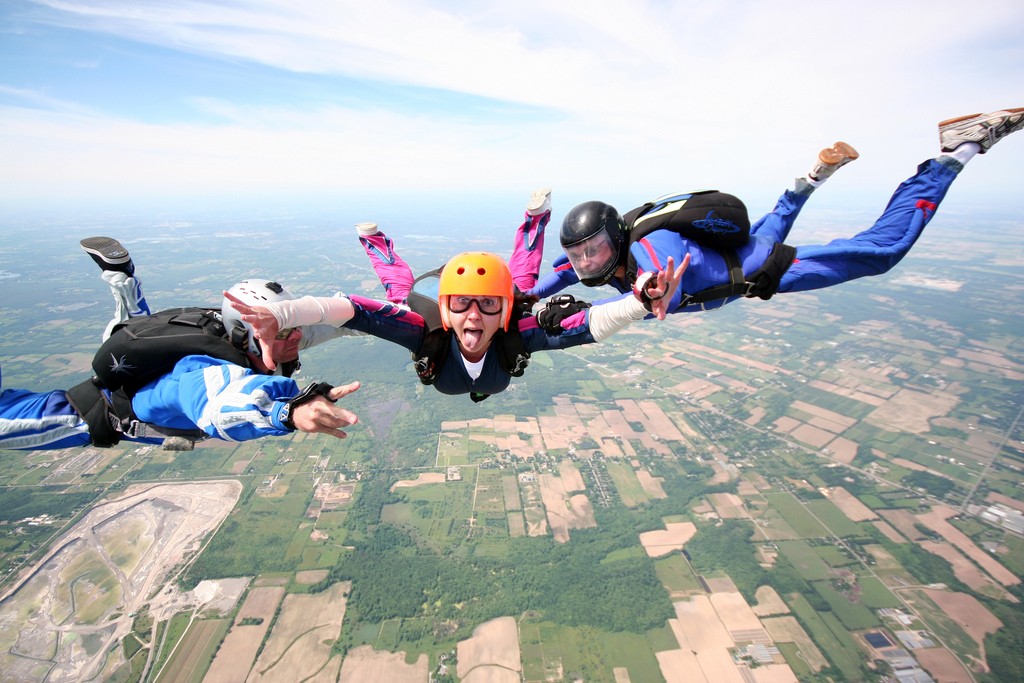 A woman skydiving with two instructors