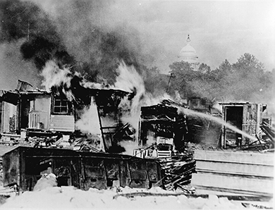 A photograph shows the burning of veterans’ camps at Anacostia Flats.
