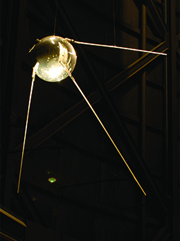 A photograph shows a replica of Sputnik.